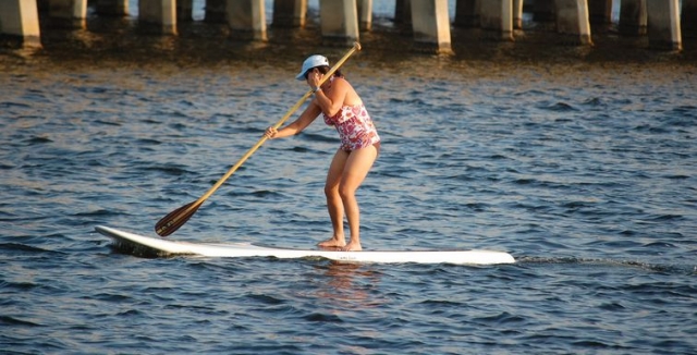 mujer practicando paddle surf en el mar